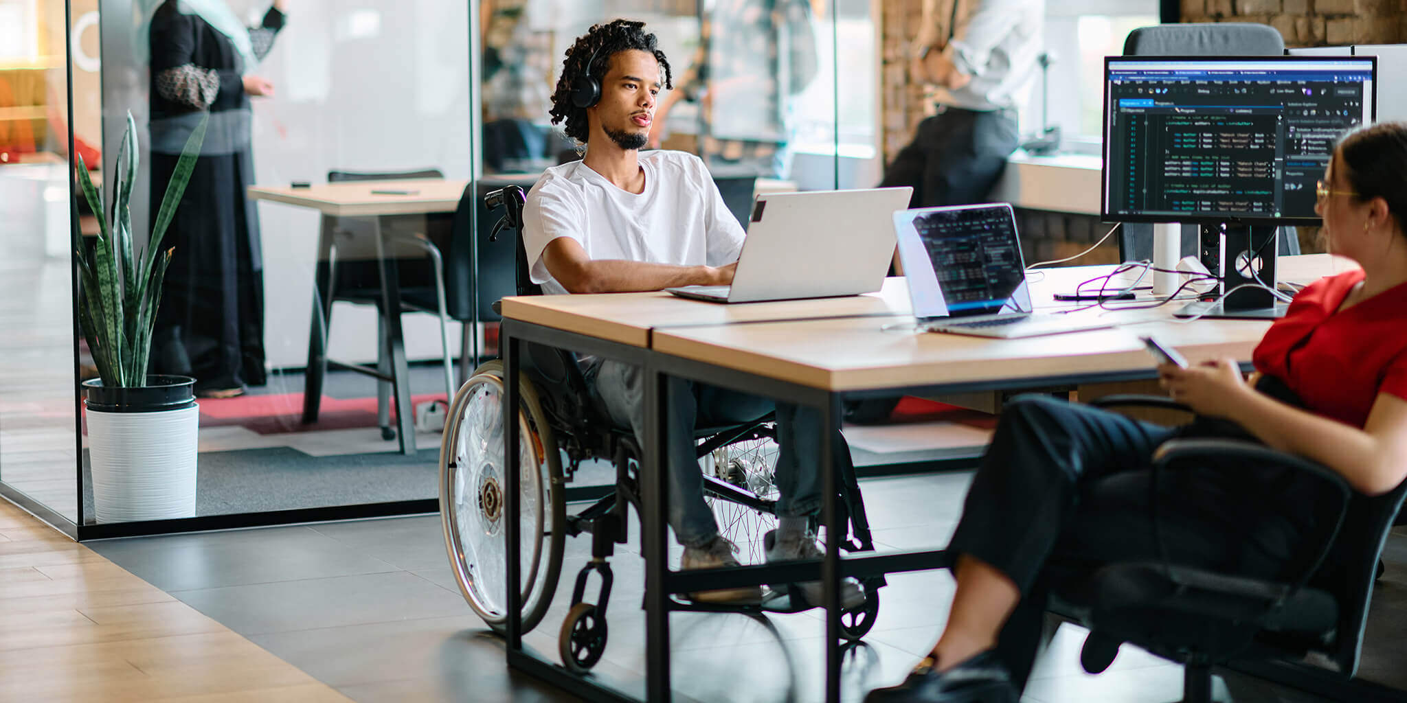 Young man in a wheelchair looking at a website on his laptop